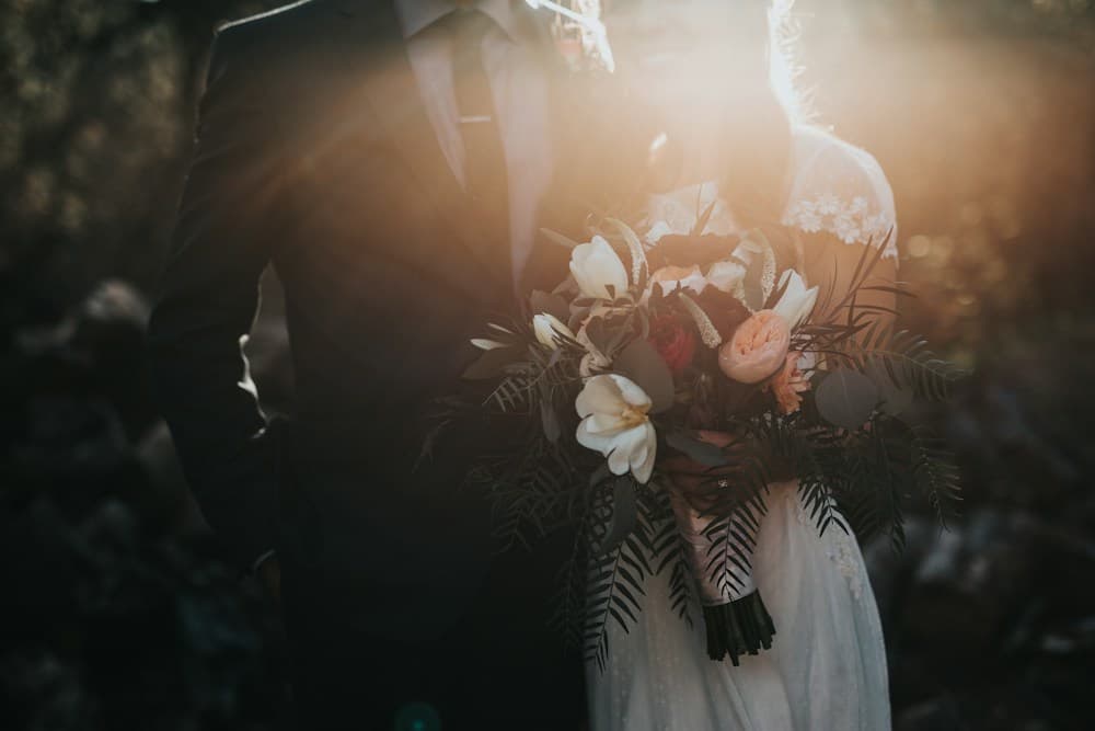 Guests celebrating a wedding beneath hanging lights